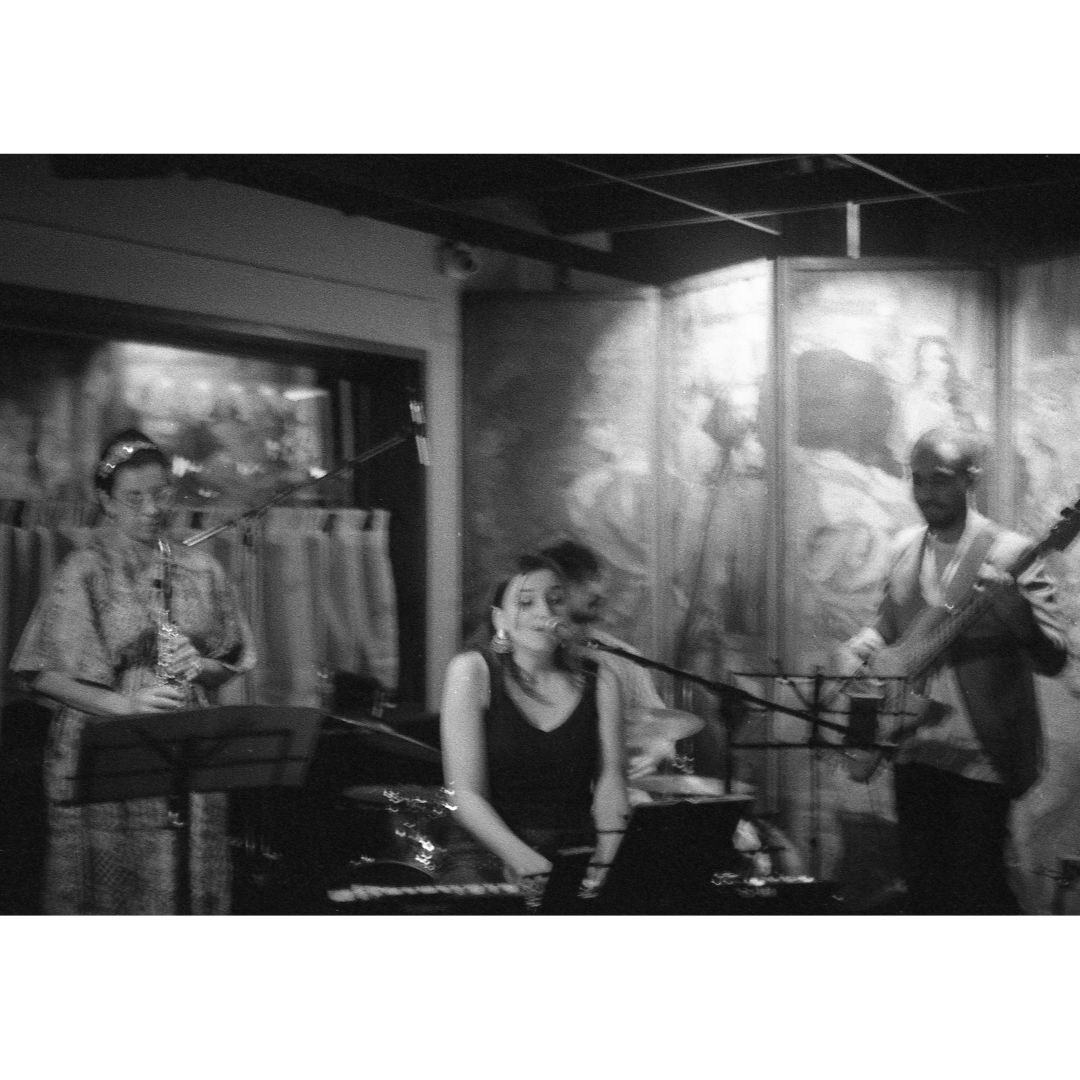 jazz band plays in a dingy club, bnw with a ton of haze